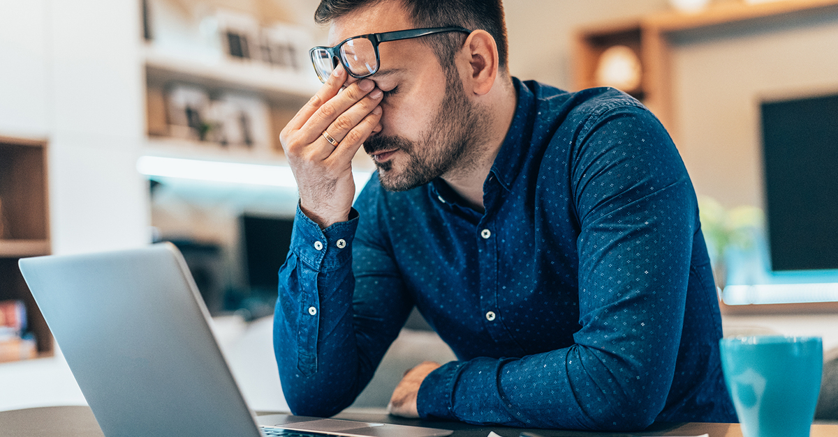 A man on a laptop dealing with frustration 